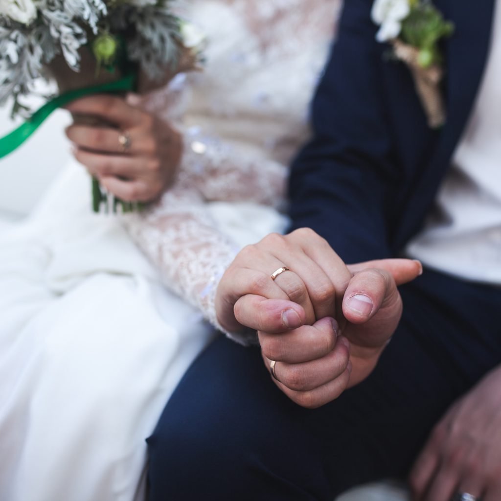 husband and wife holding each other's hands