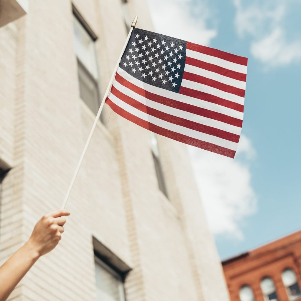 woman holding a mini US flag