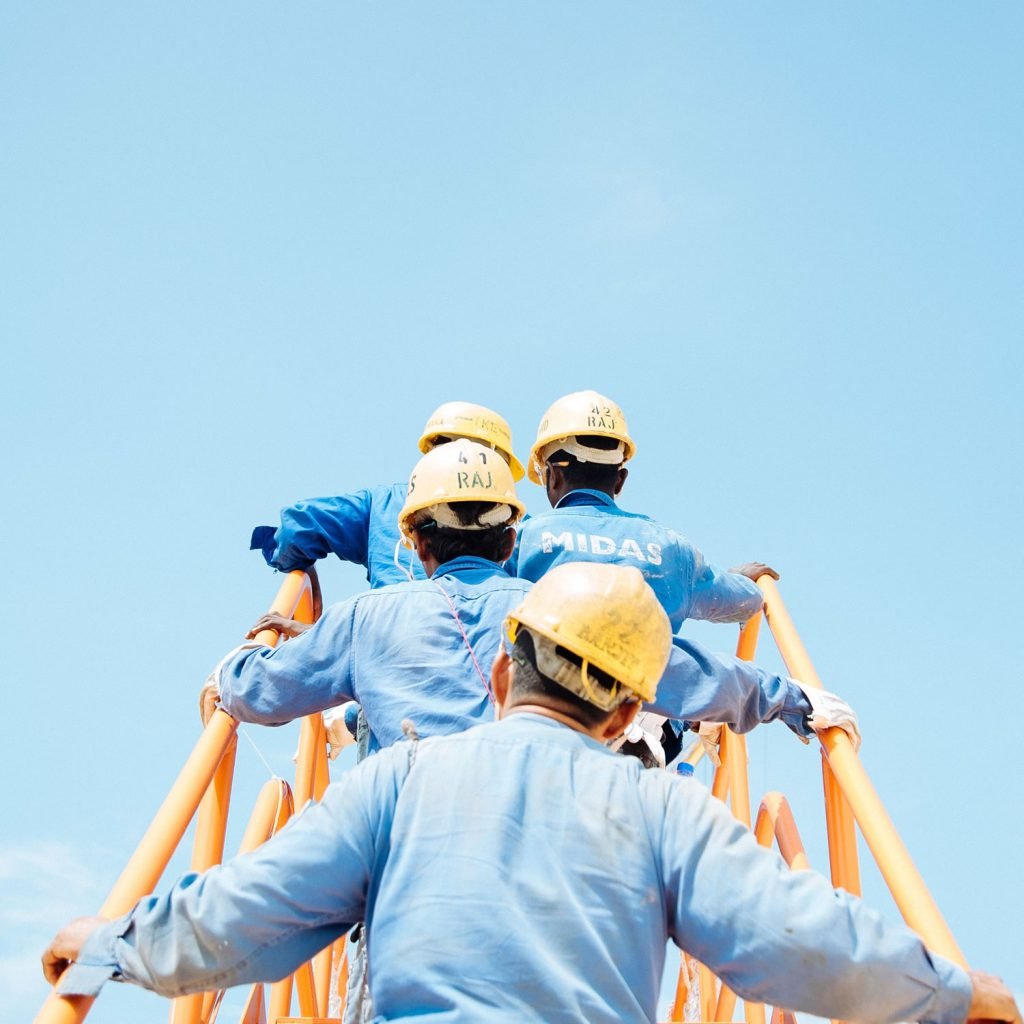 Four-Skilled-Workers-Ascending-the-Stairs-at-a-Construction-Site-unsplash