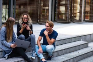 three students gathering outside their university