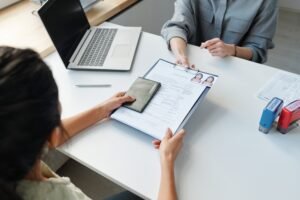 Woman Applying For Visa At Table